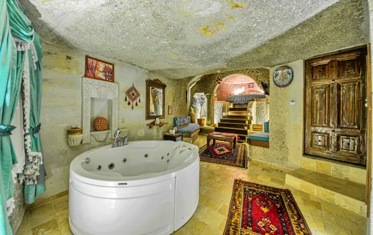 Göreme Hidden Cave Hotel jakuzili mağara oda içi, kaya oyma duvarlar ve Kapadokya otantik konaklama atmosferi